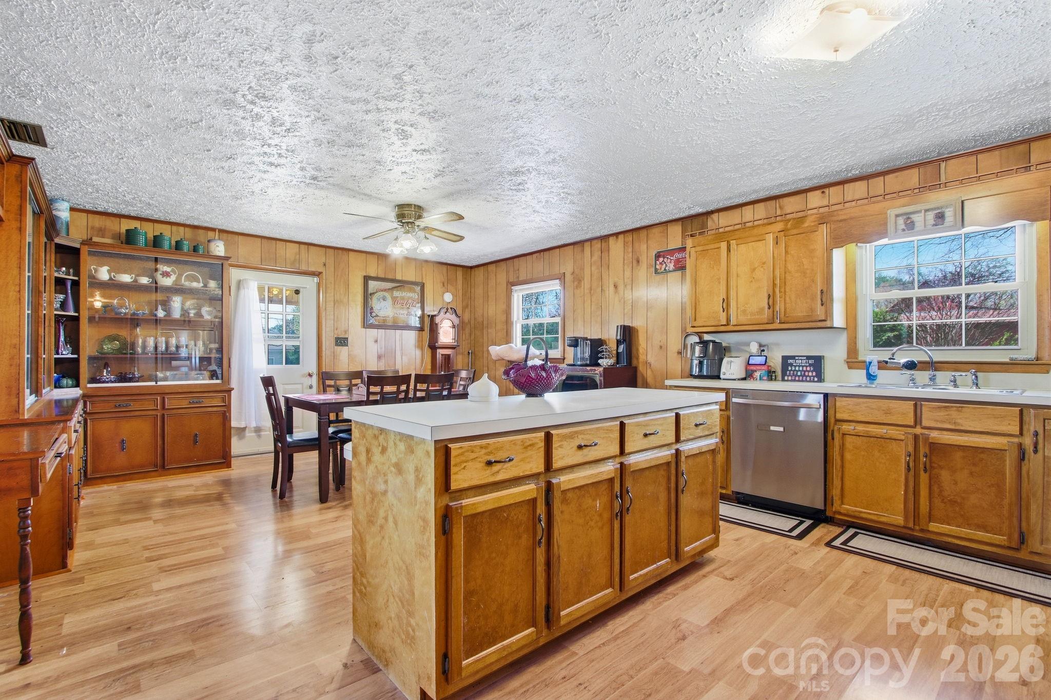3266 Coble Dairy Road Hudson, NC 28638 - Photo 14 of 37 a large kitchen with kitchen island granite countertop a large window and white cabinets