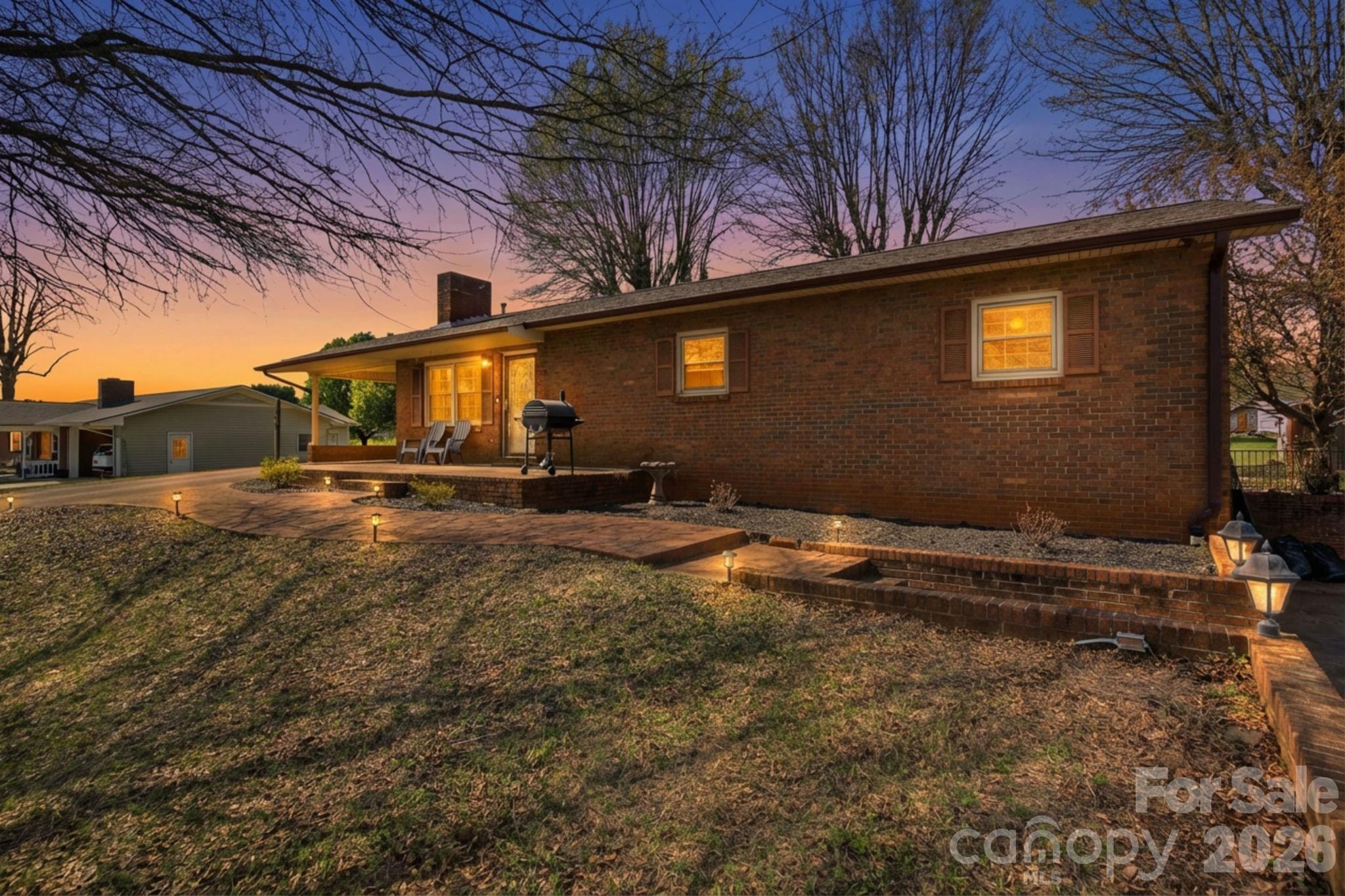 3266 Coble Dairy Road Hudson, NC 28638 - Photo 2 of 37 a backyard of a house with shaded area