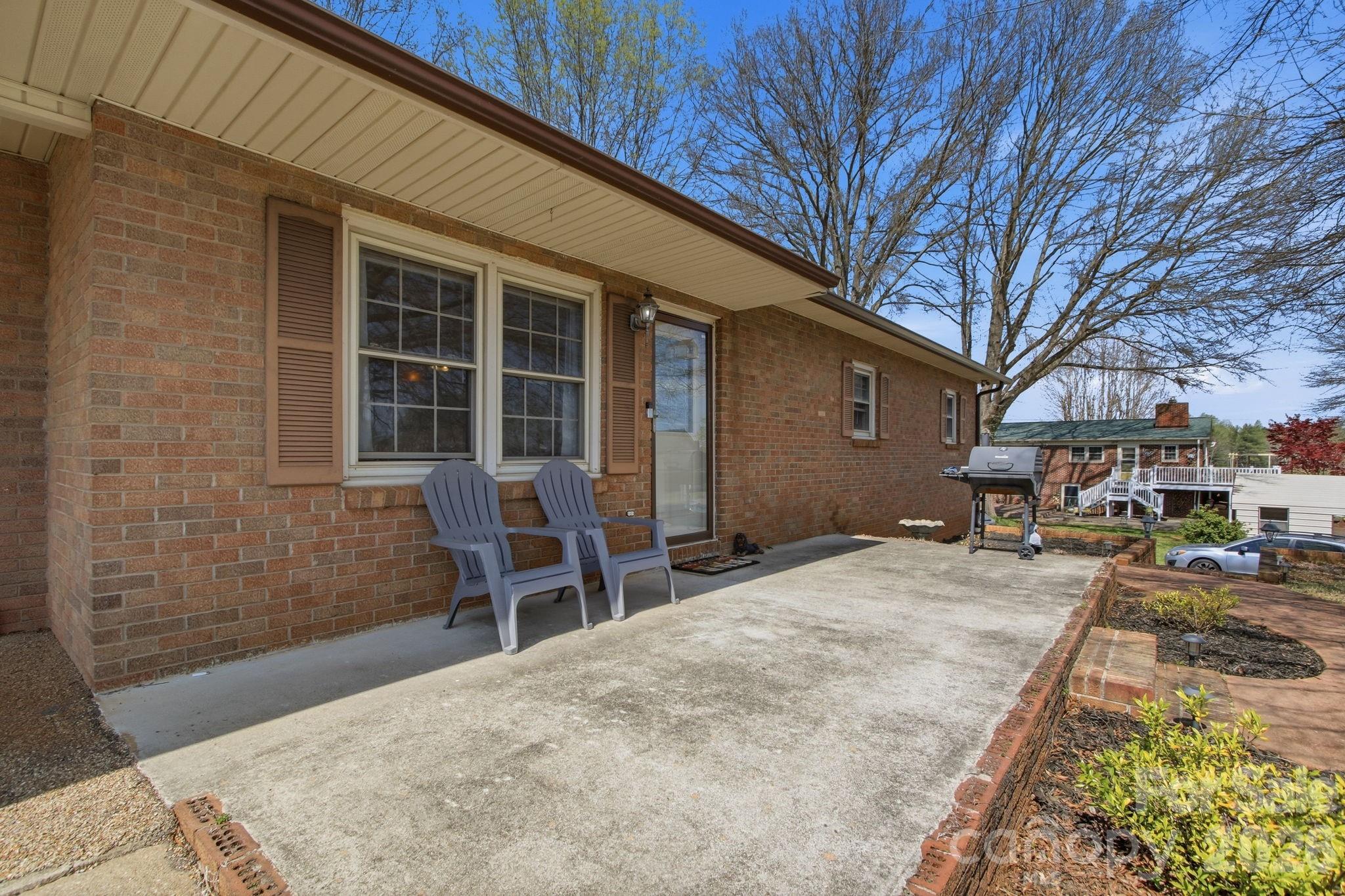 3266 Coble Dairy Road Hudson, NC 28638 - Photo 33 of 37 a backyard of a house with table and chairs