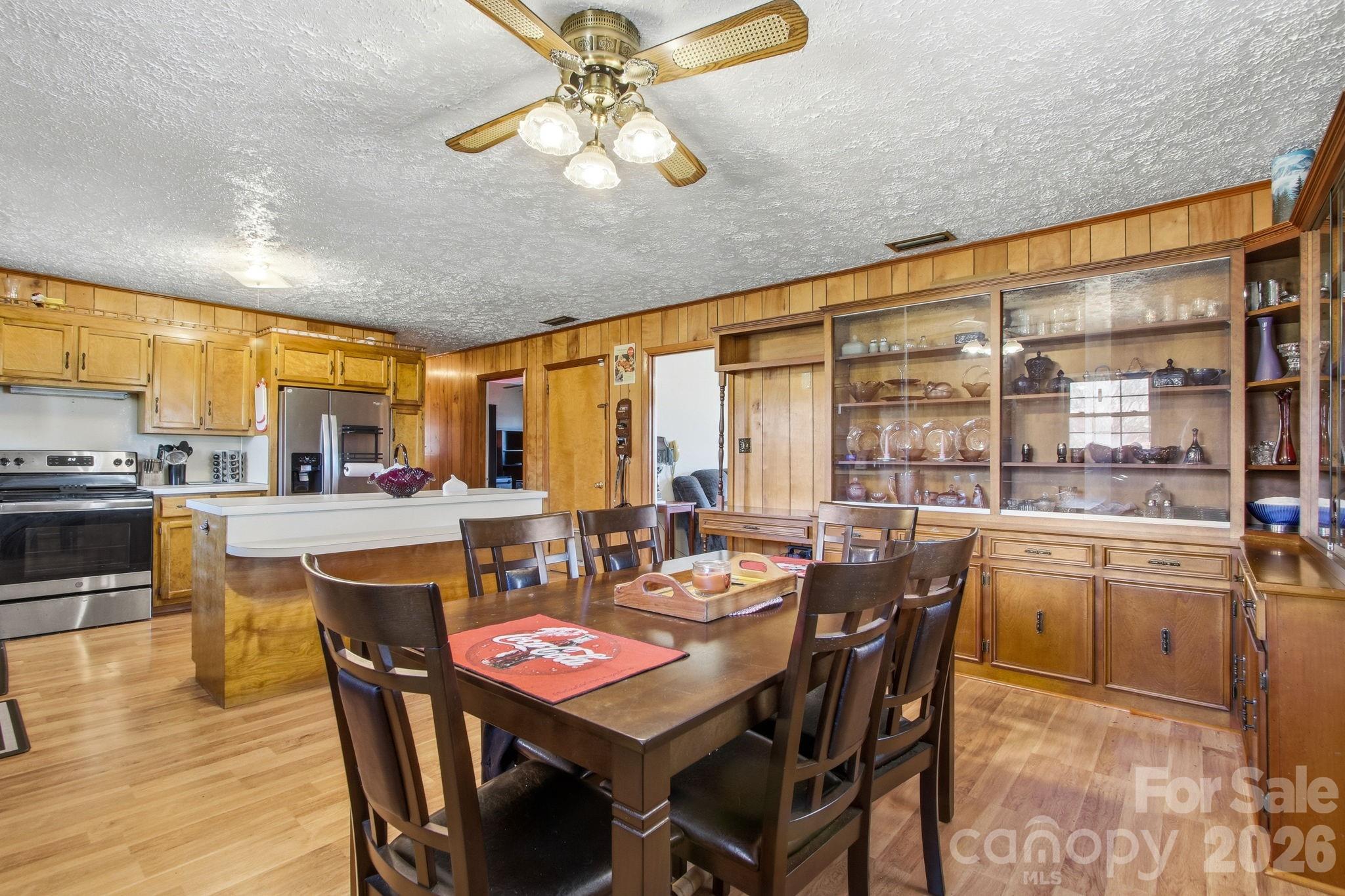 3266 Coble Dairy Road Hudson, NC 28638 - Photo 9 of 37 a dining room with furniture a chandelier and wooden floor