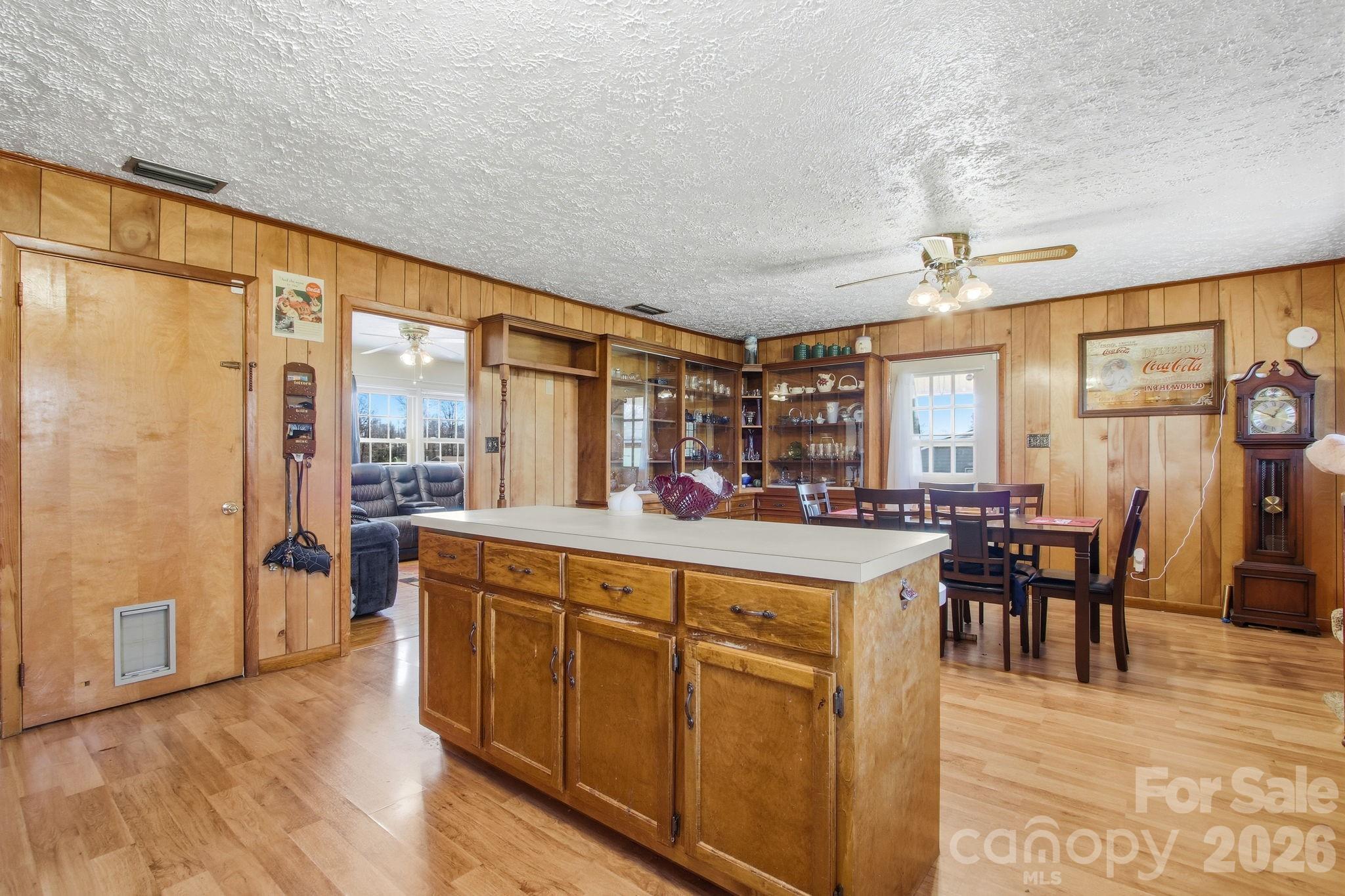 3266 Coble Dairy Road Hudson, NC 28638 - Photo 10 of 37 a open kitchen with stainless steel appliances granite countertop a refrigerator a stove and a dining table with wooden floor