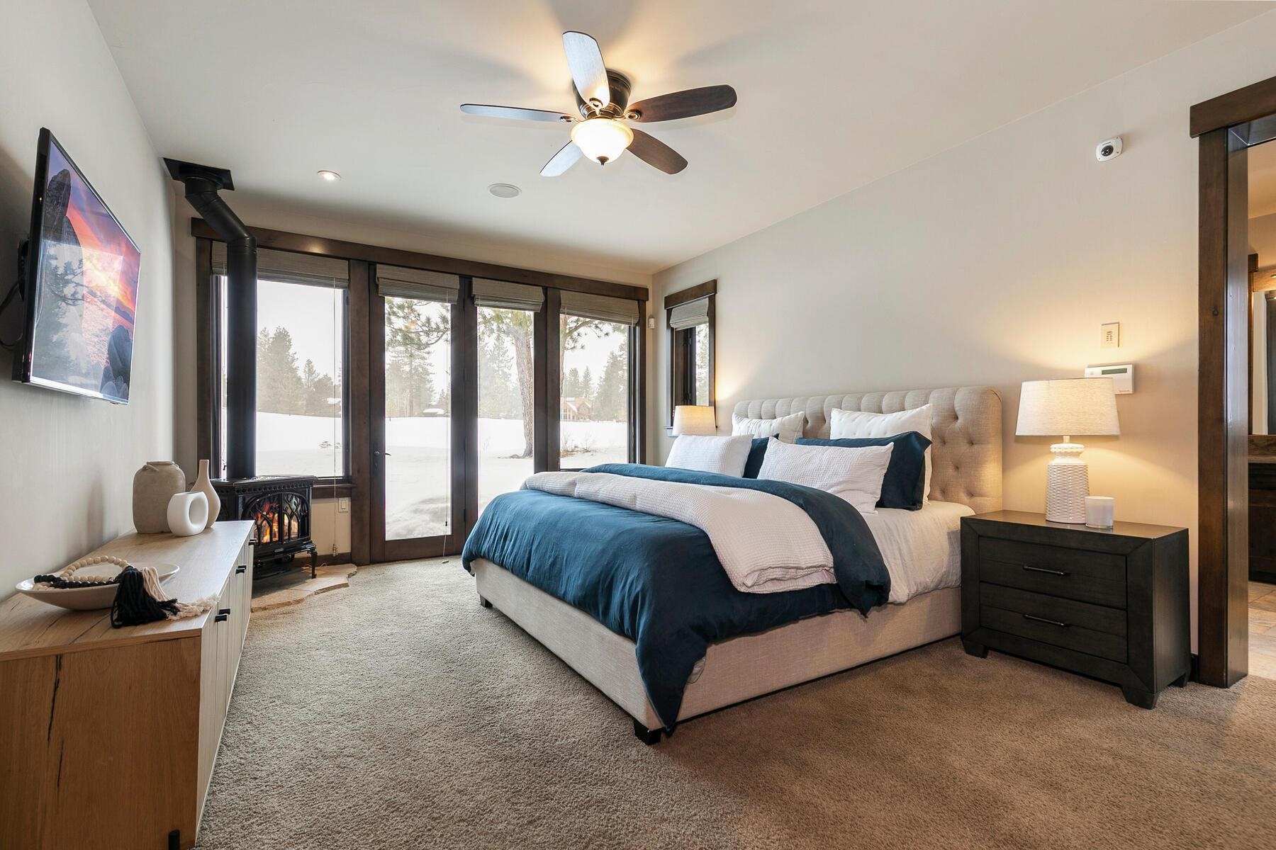 13006 Lookout Loop Truckee, CA 96161 - Photo 11 of 21 a spacious bedroom with a bed and glass windows