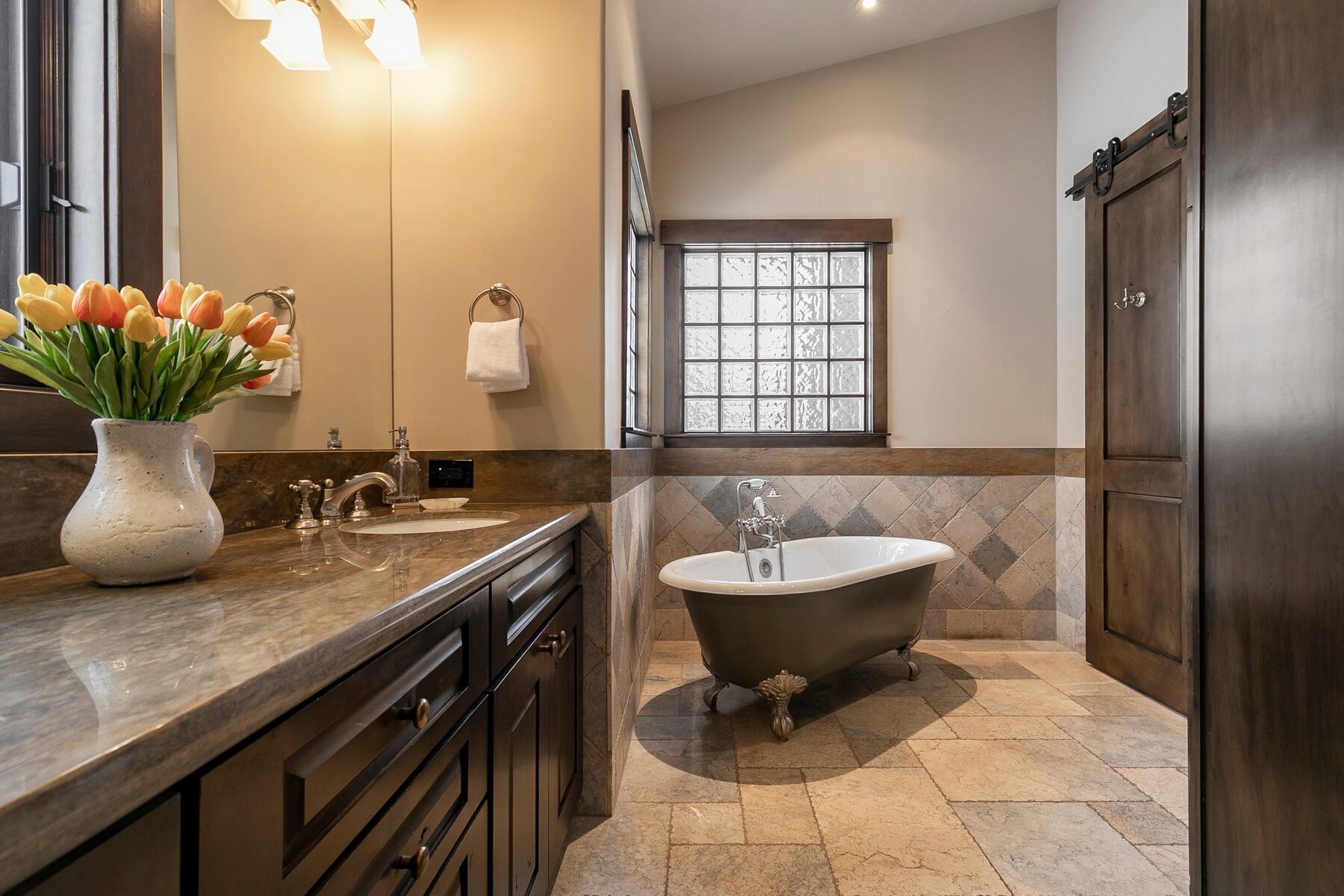 13006 Lookout Loop Truckee, CA 96161 - Photo 12 of 21 a bathroom with a granite countertop sink a toilet and mirror