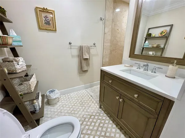 a bathroom with a granite countertop sink toilet and shower