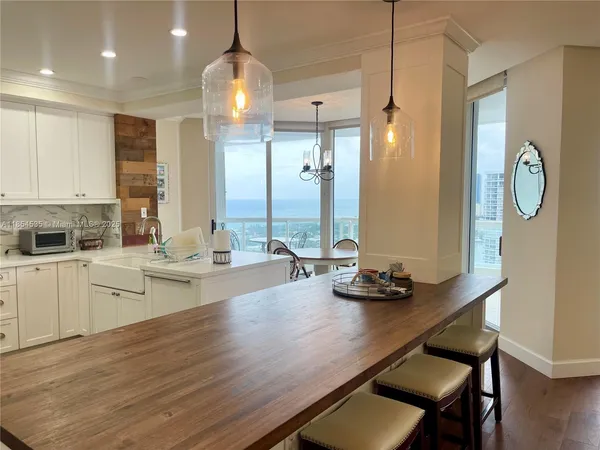 a kitchen with a table chairs sink and cabinets