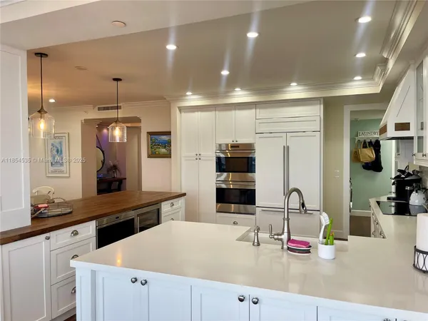 a kitchen with stainless steel appliances a refrigerator sink and cabinets