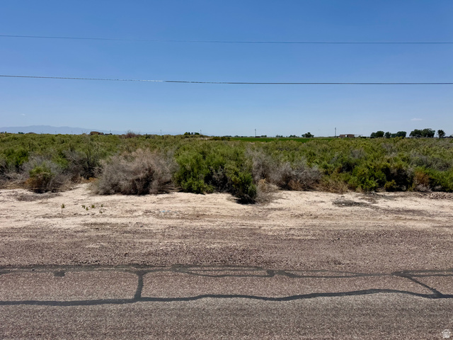 100 East 400th Street South Delta, UT 84624 - Photo 13 of 14 Expansive undeveloped land with natural vegetation and distant structures under a clear sky