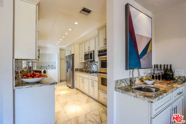 a kitchen with a sink cabinets and appliances