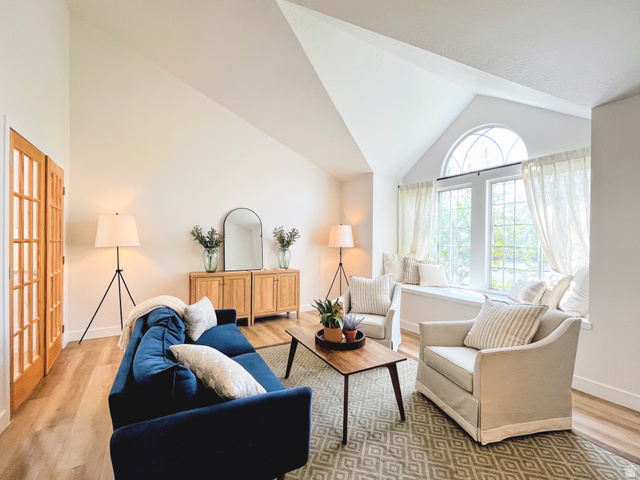 12169 Hidden Valley Road, Unit 44 Sandy, UT 84092 - Photo 9 of 49 Vaulted ceilings, wood-finish flooring, French doors, a built-in window seat, and an arched transom window