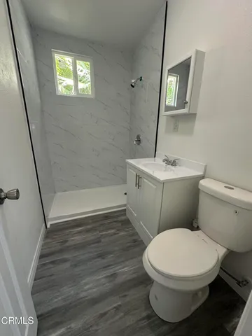 a white toilet sitting next to a bathroom sink