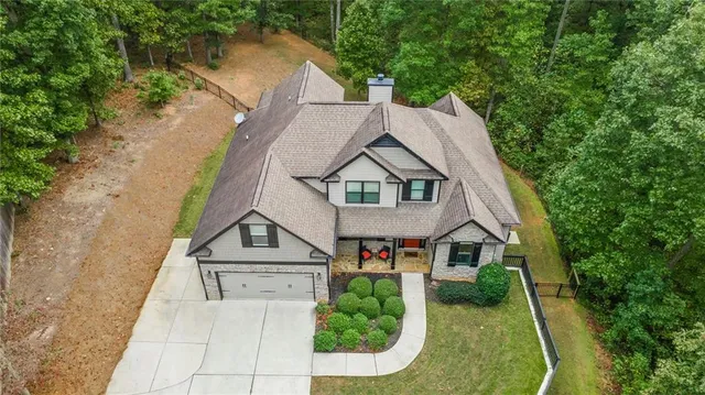a aerial view of a house with swimming pool next to a yard