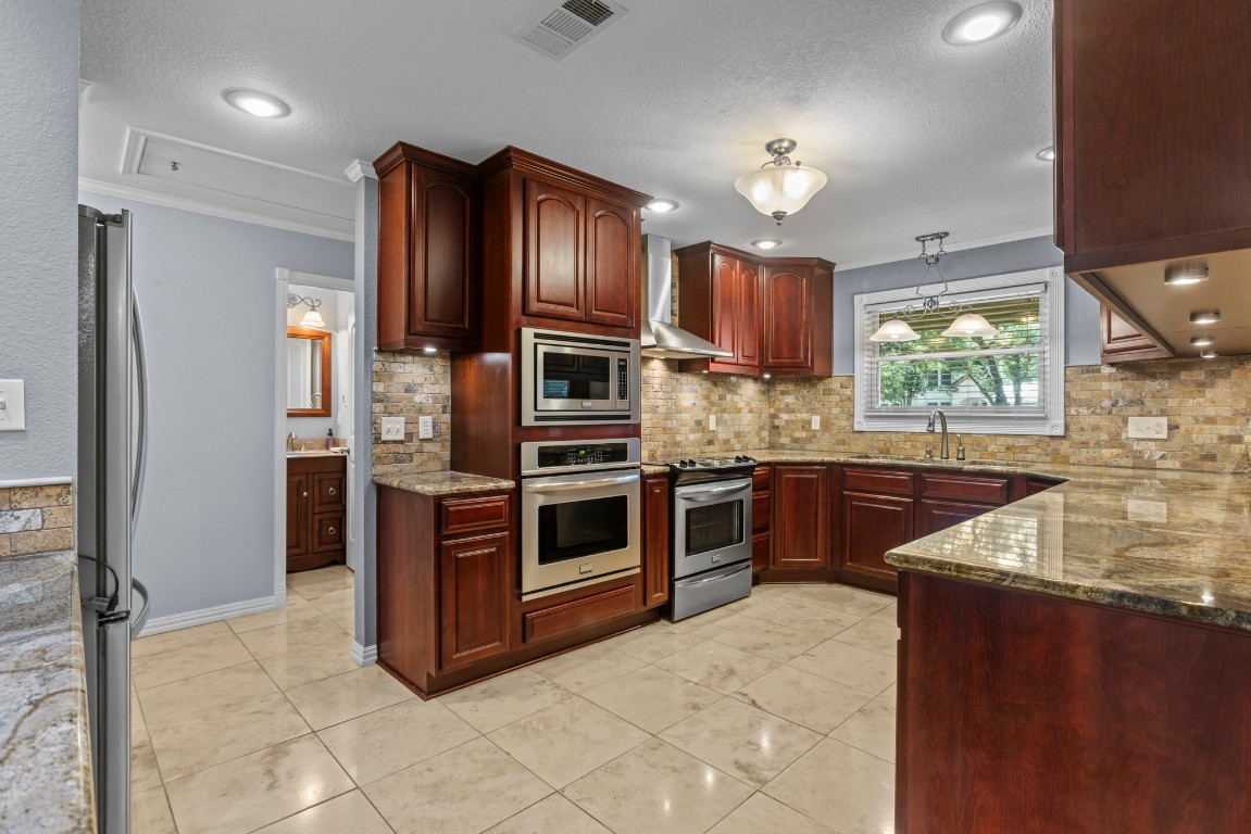 3745 Canyon Heights Road Belton, TX 76513 - Photo 13 of 29 a kitchen with stainless steel appliances granite countertop a refrigerator a sink a stove and oven