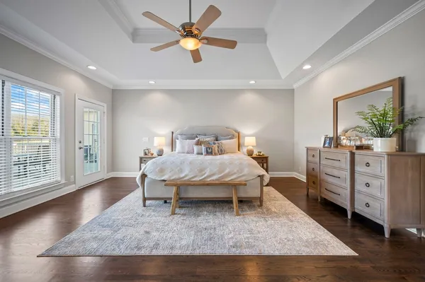 a bedroom with a large bed and a chandelier