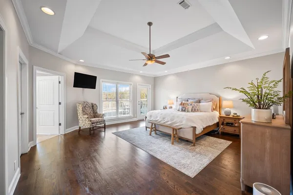 a bedroom with furniture and a large window