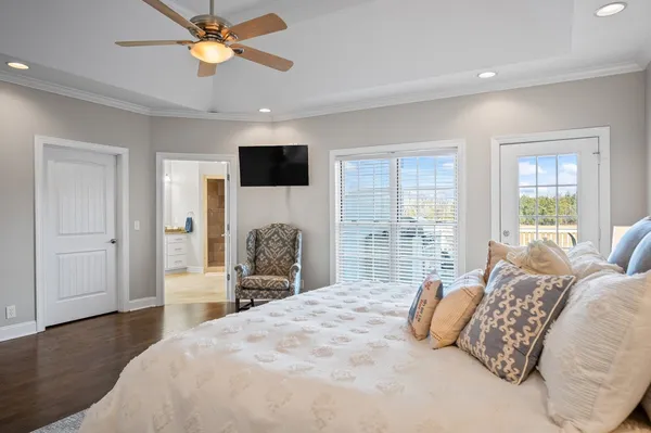 a spacious bedroom with a large bed and a flat screen tv