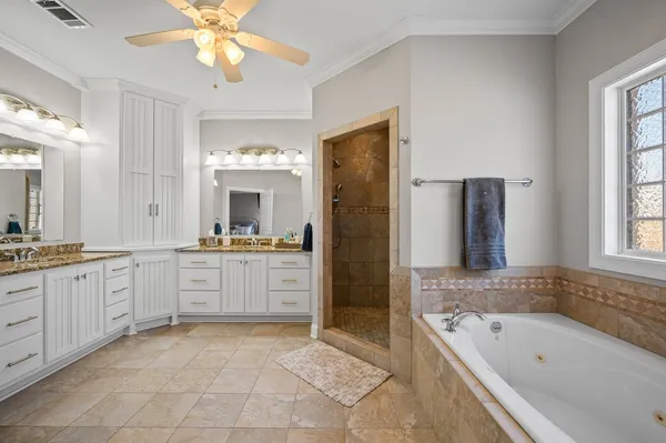 a large bathroom with a tub sink shower and mirror