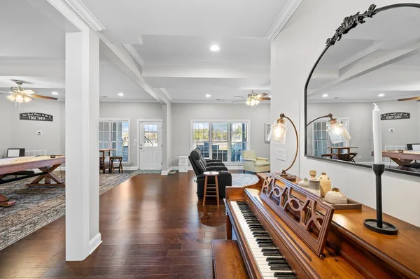 a living room with lots of furniture and wooden floor