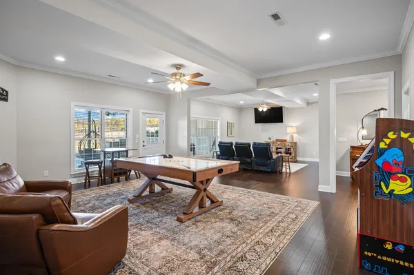 a living room with furniture and wooden floor