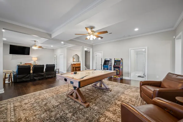 a living room with furniture a flat screen tv and a table