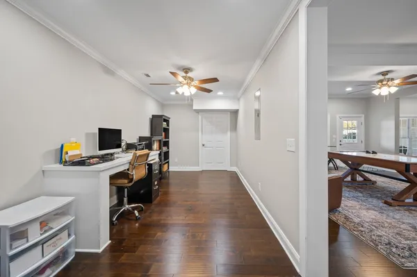 a view of a workspace with furniture and wooden floor
