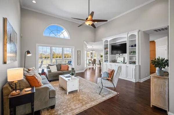 a living room with furniture a rug and a flat screen tv