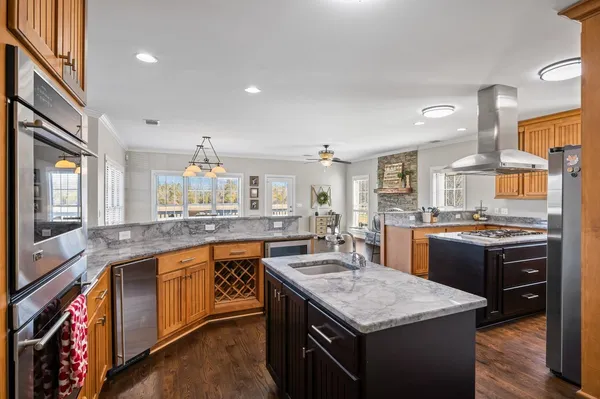 a kitchen with granite countertop a sink stove and cabinets