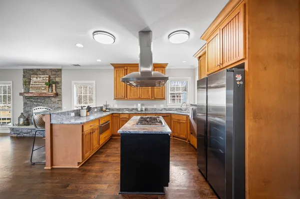 a kitchen with stainless steel appliances granite countertop a stove a sink and a refrigerator