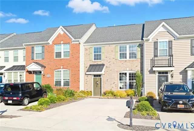 a front view of a house with a yard and outdoor seating