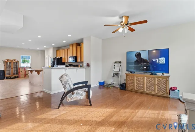 a living room with furniture and kitchen view