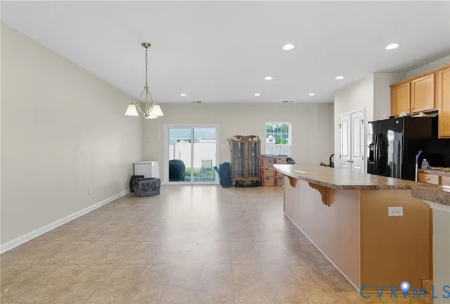 a large kitchen with a large counter top appliances and furniture