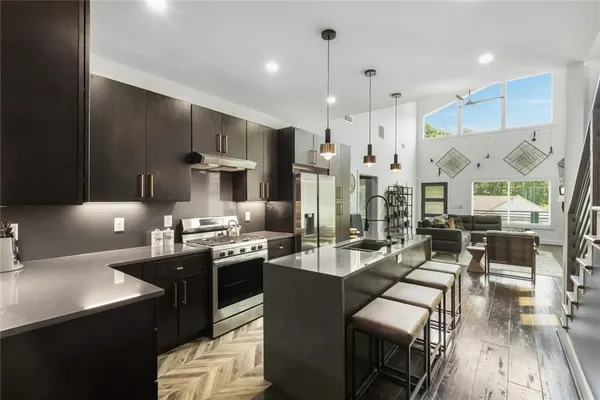 a large kitchen with lots of counter space and stainless steel appliances