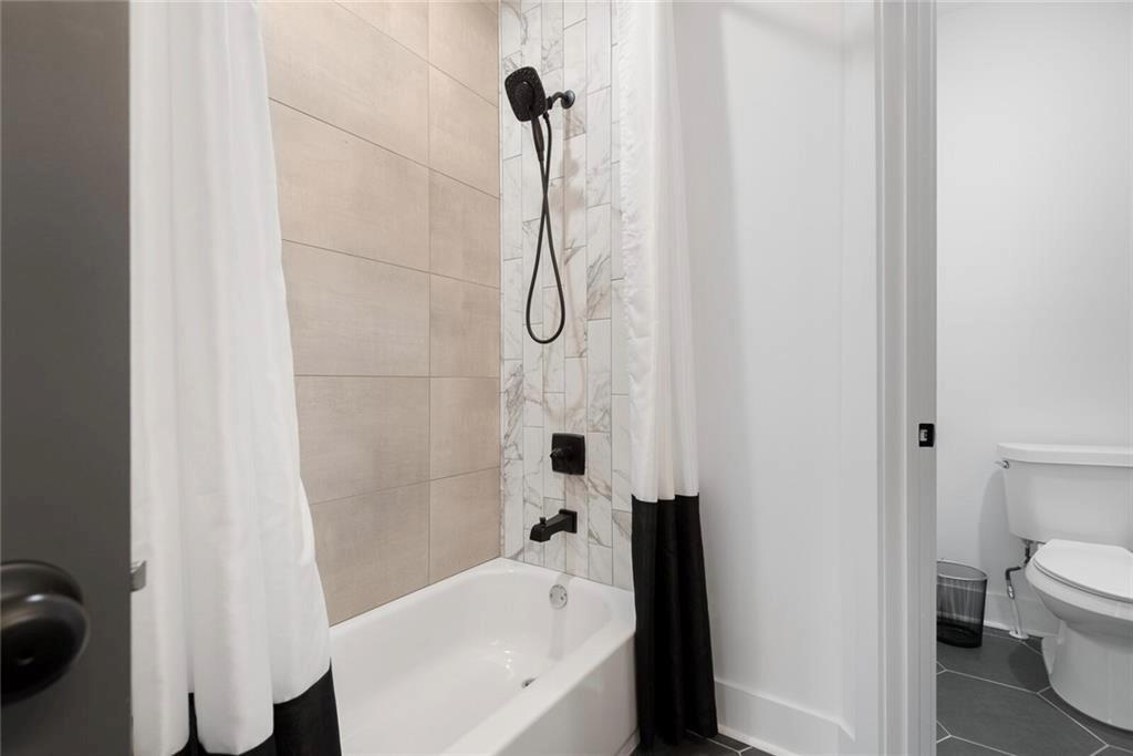 255 Mathewson Place Southwest Atlanta, GA 30314 - Photo 19 of 32 a bathroom with a bathtub a sink a toilet and a shower