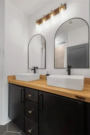 a bathroom with a double vanity sink and a mirror