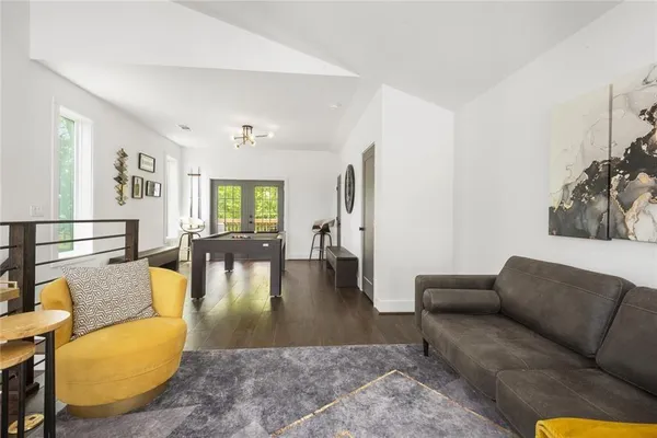a living room with furniture wooden floor and a large window