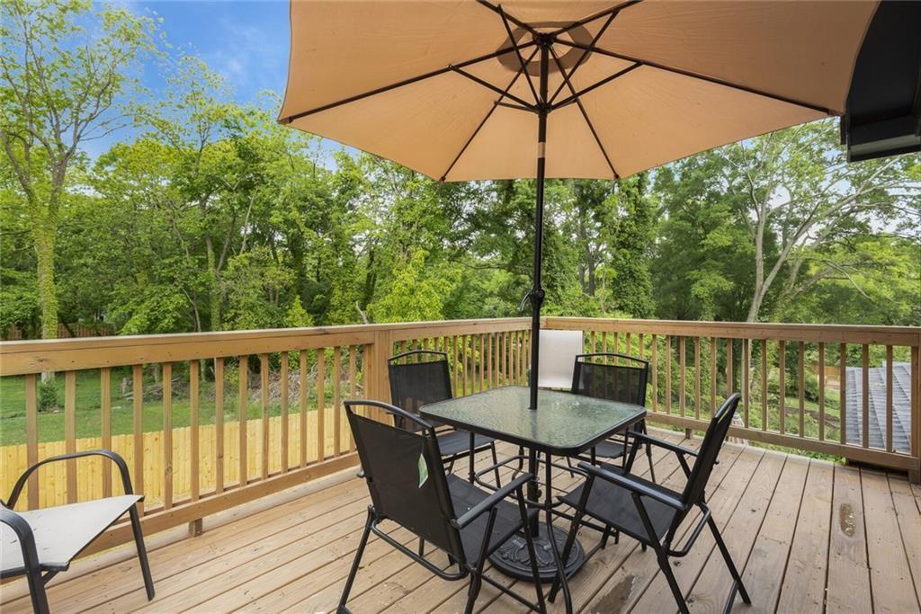 255 Mathewson Place Southwest Atlanta, GA 30314 - Photo 24 of 32 a view of a wooden deck with furniture and umbrella