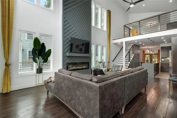 a living room with furniture a fireplace and a potted plant