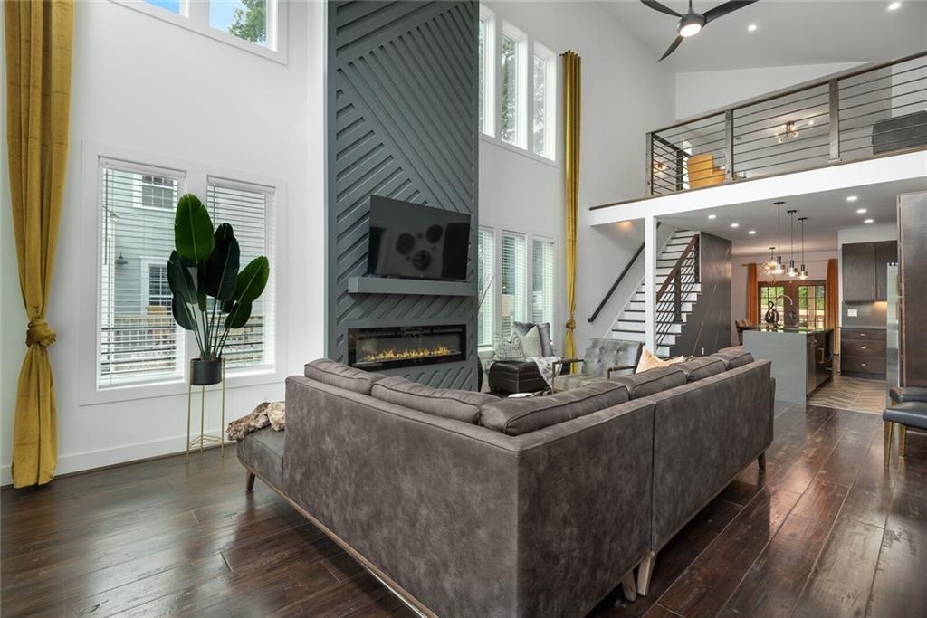 255 Mathewson Place Southwest Atlanta, GA 30314 - Photo 5 of 32 a living room with furniture a fireplace and a potted plant