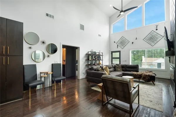a living room with dining room and wooden floor