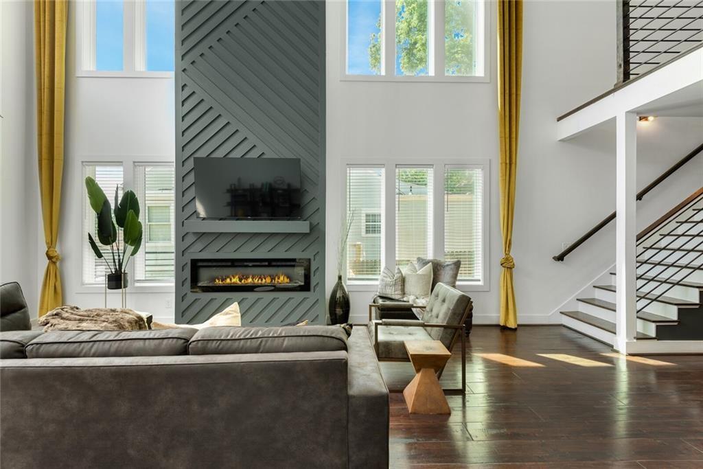 255 Mathewson Place Southwest Atlanta, GA 30314 - Photo 9 of 32 a living room with fireplace furniture and a flat screen tv