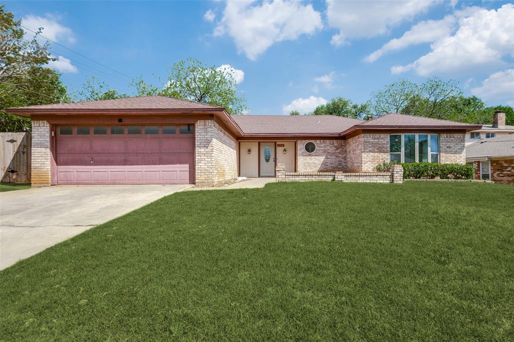 324 Cannon Drive Hurst, TX 76054 - Photo 1 of 1 a front view of a house with a garden and plants
