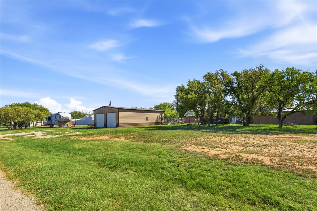 4441 Pawnee Drive May, TX 76857 - Photo 11 of 12 a big yard with lots of green space and palm trees