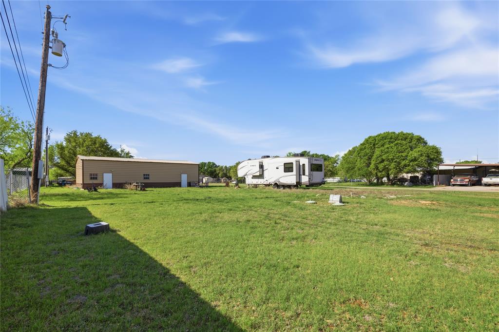 4441 Pawnee Drive May, TX 76857 - Photo 6 of 12 a yellow house with garden in front of it