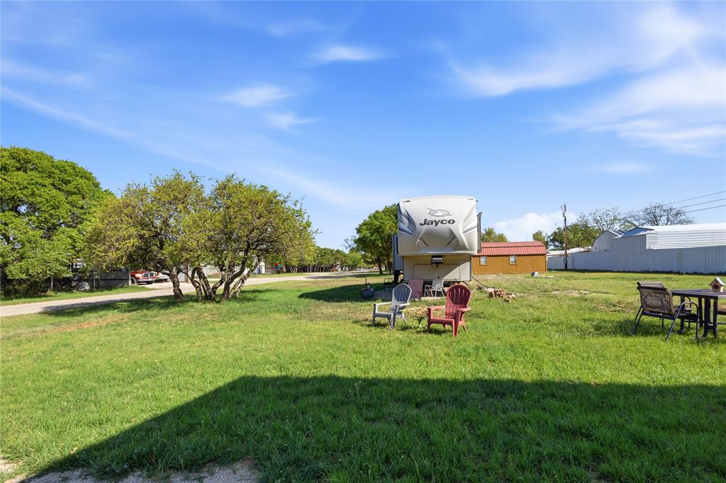 4441 Pawnee Drive May, TX 76857 - Photo 8 of 12 a view of a park with swings and slides