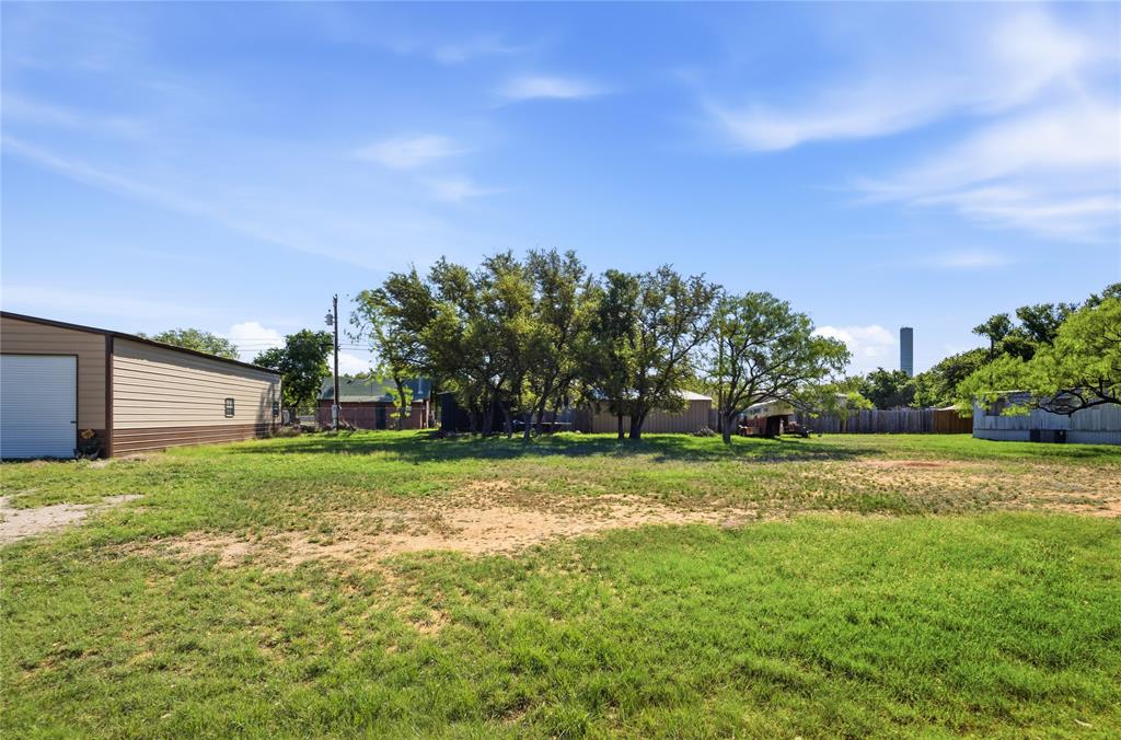 4441 Pawnee Drive May, TX 76857 - Photo 10 of 12 a view of a big yard with a house in the background