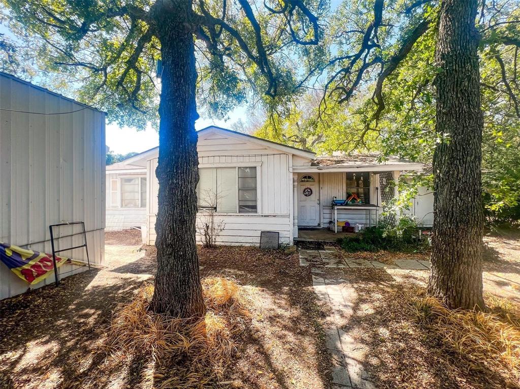 1833 W Highway, Unit AZ Springtown, TX 76082 - Photo 16 of 18 a view of a house with a tree in the backyard