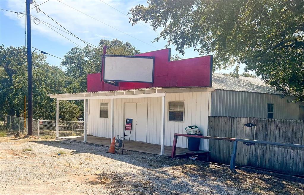 1833 W Highway, Unit AZ Springtown, TX 76082 - Photo 18 of 18 a view of a house with wooden fence and a tree