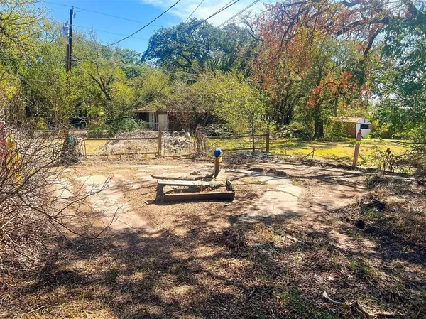 a view of yard with swimming pool and trees