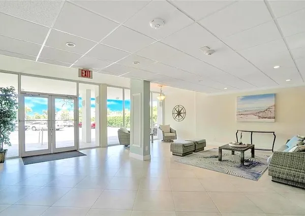 a lobby with furniture and floor to ceiling window