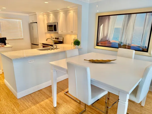 a kitchen with a sink cabinets and wooden floor