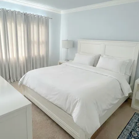 a bedroom with a bed and curtain